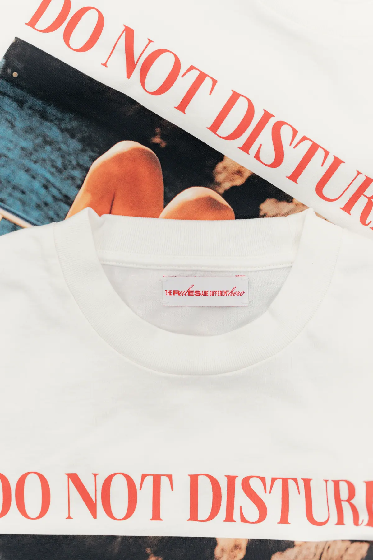 Printed white T-shirt with the Do Not Disturb artwork laid on a table