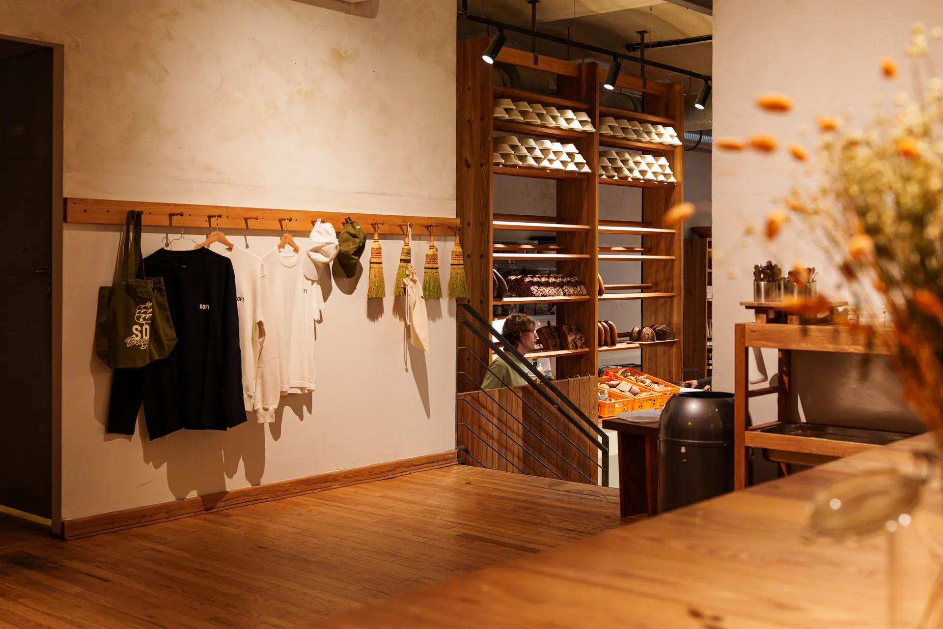 Sofi Bakery shop interior with the team wardrobe hanging on hooks beside the counter
